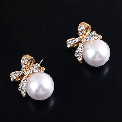 Gleaming Bow Bold Pearl Stud Earrings