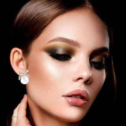 Gleaming Bow Bold Pearl Stud Earrings
